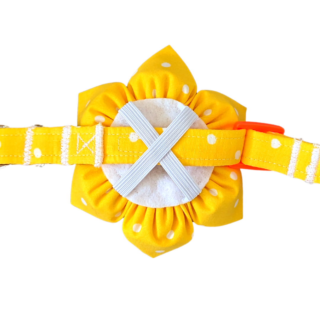 Image showing the back of the Yellow Polka Dot Kanzashi Flower with a collar looped through the elastic X shape. The flower has a round felt backing with stitched garters.