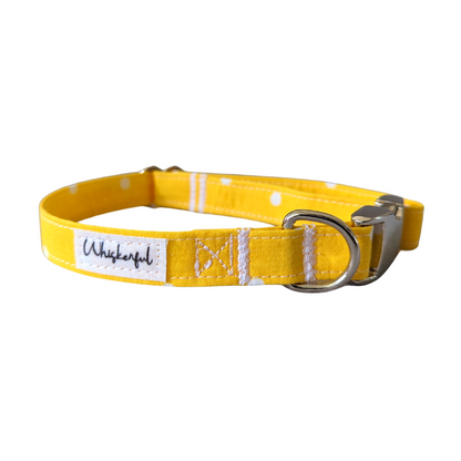 Image of our Medium Yellow Polka Dot Collar featuring medium interfacing inside to maintain its shape. The collar is equipped with contoured aluminum hardware for enhanced comfort on pets.