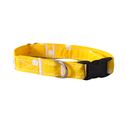 Image of our Small Yellow Polka Dot Collar featuring a black buckle with an aluminum slider and an aluminum D-ring. The collar is designed with both a breakaway buckle option for added safety and a regular buckle for those who prefer it. The hardware is contoured for comfort and provides a secure attachment point for name tags and identification for pets.